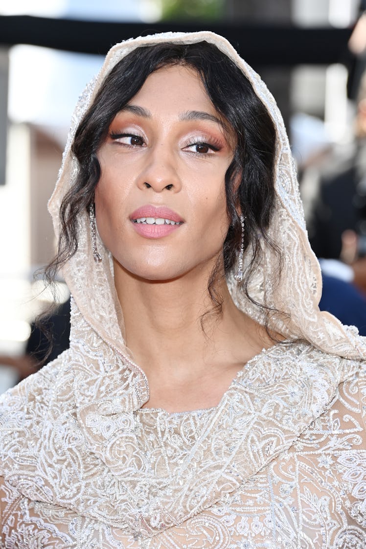 MJ Rodriguez in a beige sequin dress with a hoodie at the Cannes Film Festival 2021