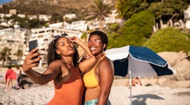 2 friends posing for a selfie in Miami Beach before posting on Instagram with a Miami caption.