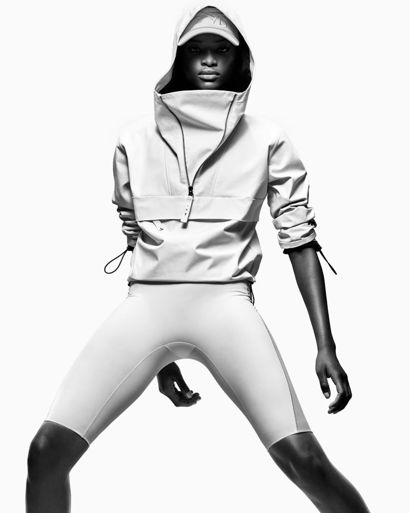 Model wears a white anorak jacket and capri shorts from Reebok x Victoria Beckham Drop 5, releasing ...