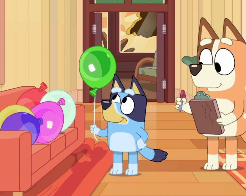 Still from 'Bluey'; Bluey holding balloon with mom who is holding a clipboard