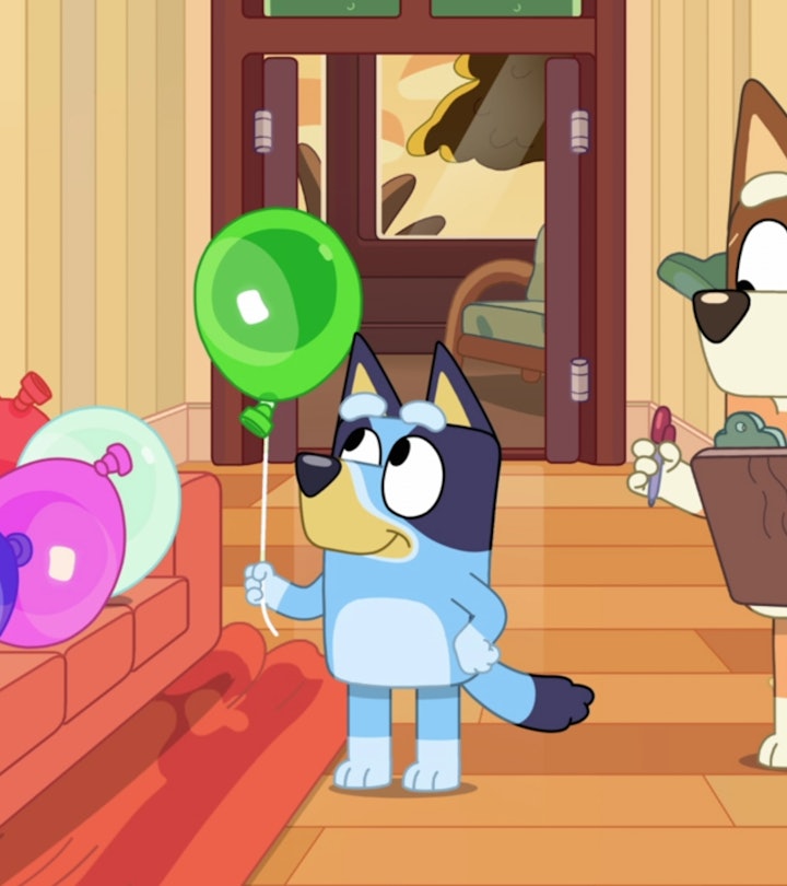 Still from 'Bluey'; Bluey holding balloon with mom who is holding a clipboard