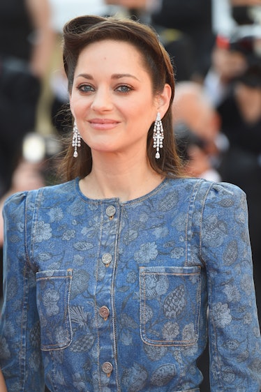 Marion Cotillard in a floral denim dress and crystal earrings  at the Cannes Film Festival 2021