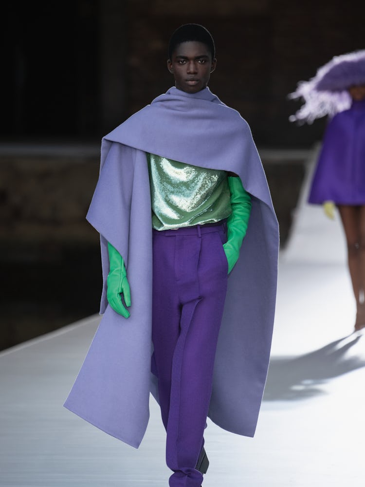 A model in a purple scarf and pants, lime sequin top and gloves at the Valentino Couture Fall 2021 C...