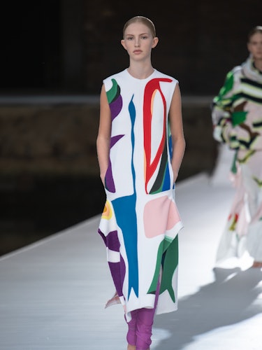 A model in a multi-color illustrated dress at the Valentino Couture Fall 2021 Couture