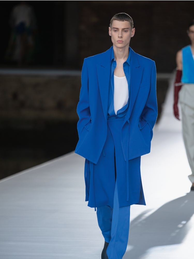 A model in a blue suit and white shirt at the Valentino Couture Fall 2021 Couture