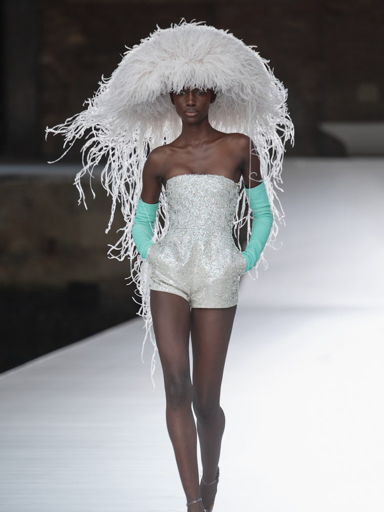 A model in a white sequin jumpsuit at the Valentino Couture Fall 2021 Couture