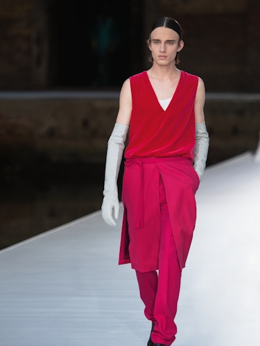 A model in a red top and skirt-pants at the Valentino Couture Fall 2021 Couture