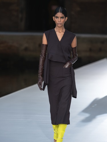 A model in a black top, skirt, and gloves at the Valentino Couture Fall 2021 Couture