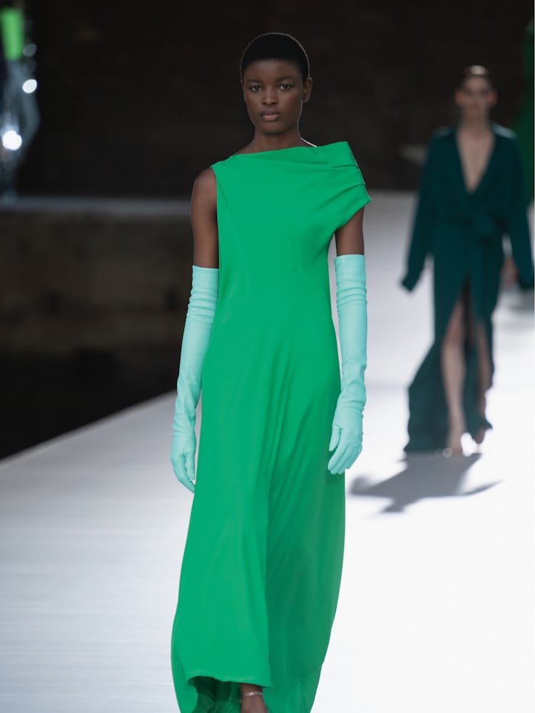 A model in a green dress and gloves at the Valentino Couture Fall 2021 Couture