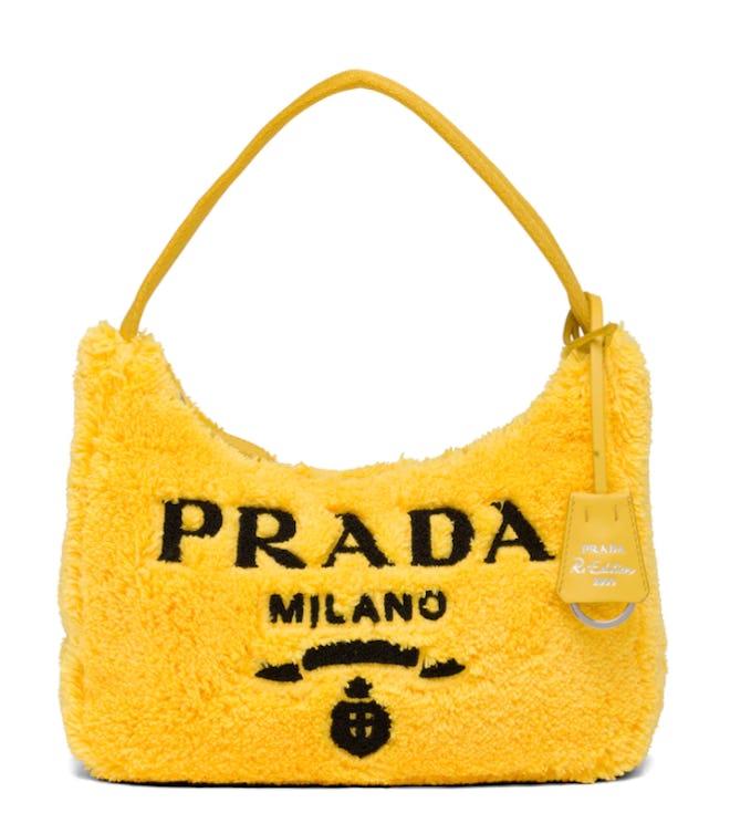 A yellow Prada Re-Edition 2000 bag. 