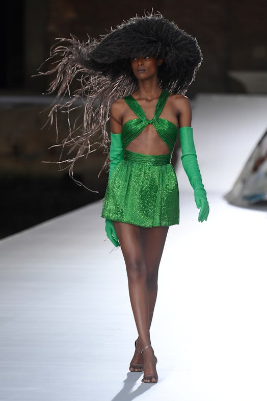 A model in a green shimmer dress and gloves at the Valentino Couture Fall 2021 Couture