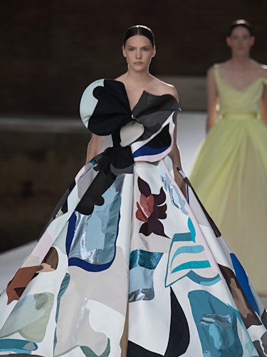 A model in a multi-color layered gown at the Valentino Couture Fall 2021 Couture