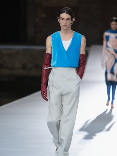 A model in a blue top and beige pants at the Valentino Couture Fall 2021 Couture