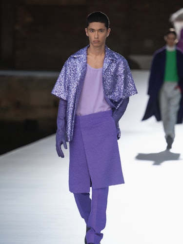 A model in a purple jacket, top, skirt-pants at the Valentino Couture Fall 2021 Couture