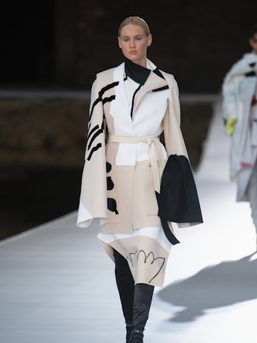 A model in a beige-white-black coat at the Valentino Couture Fall 2021 Couture