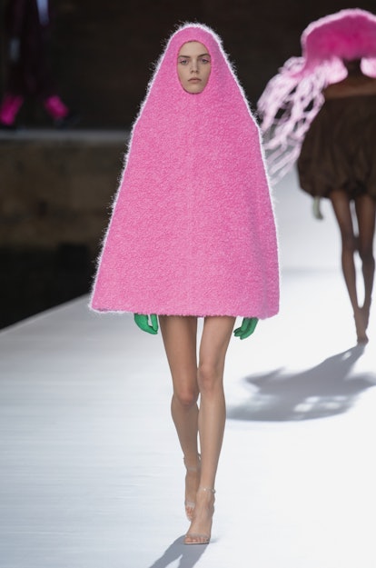 A female model walking in a pink babushka Valentino dress