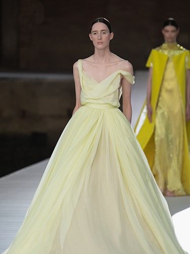 A model in a pale yellow tulle dress at the Valentino Couture Fall 2021 Couture