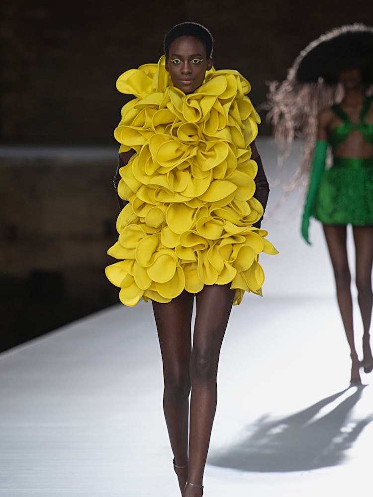 A model in a short frilled dress at the Valentino Couture Fall 2021 Couture