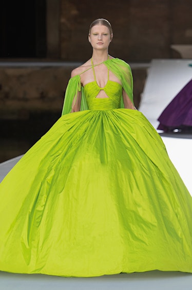 A model walking the runway in a lime, floor-length gown with a puffy skirt by Valentino 