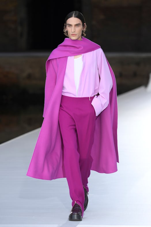 A model in a pink coat, light-pink shirt and purple-pink pants at the Valentino Couture Fall 2021 Co...