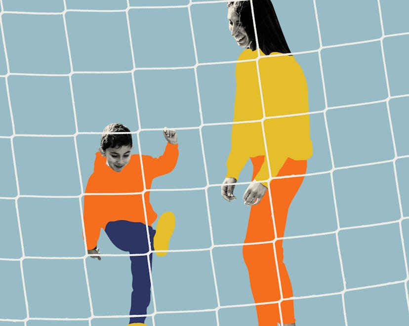 A soccer mom standing in goal, playing soccer with her son