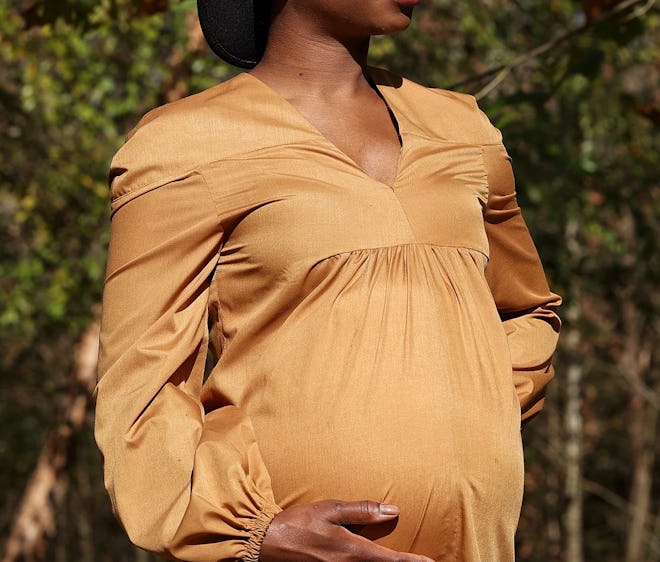 cotton maternity dress in golden color with long sleeves and symmetrical hem