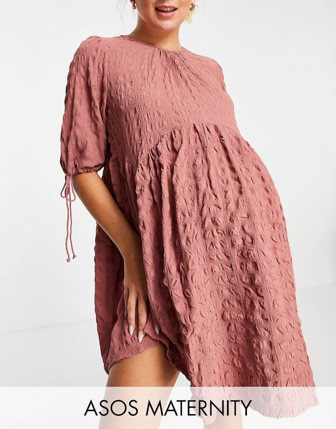 textured pink maternity mini dress with empire waist and ties on the sleeves