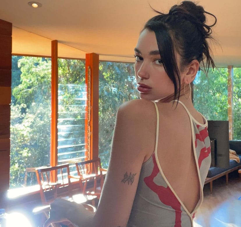 Dua Lipa looking over shoulder