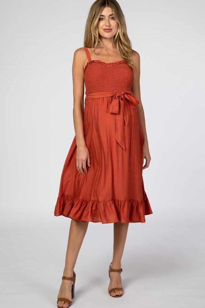 rust colored maternity dress with smocked bodice and ruffle hem