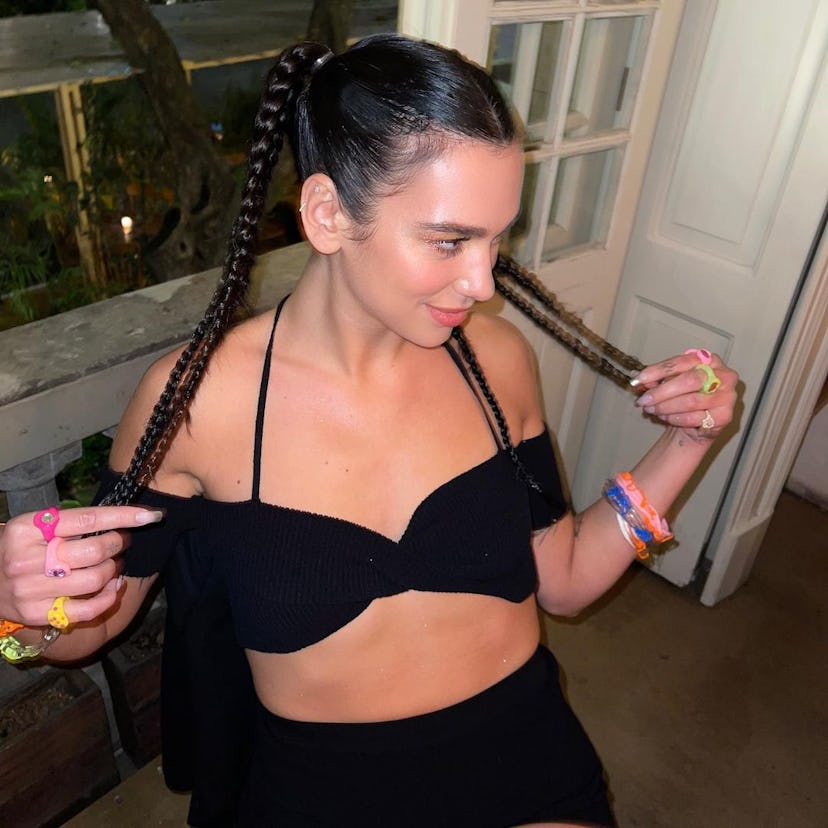 Dua Lipa posing with braided pigtails