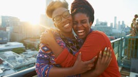 Young woman hugging her sister, wishing her a happy engagement with sister engagement caption, siste...