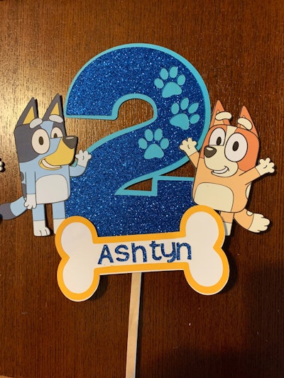 Cake topper with the number "2" and Bluey and Bingo characters from "Bluey"