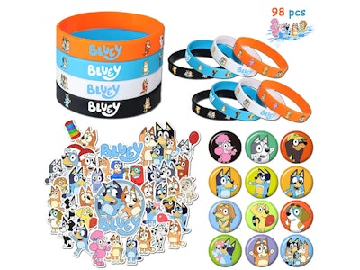 Piles of "Bluey" themed party favors; bracelets, stickers, and pins