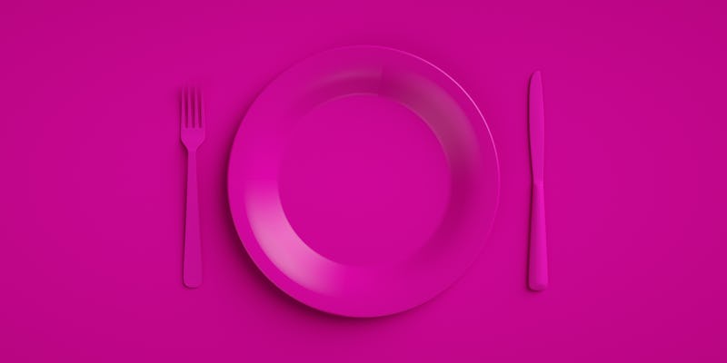 An empty purple plate with purple cutlery on a purple background