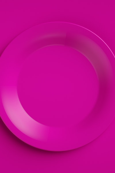 An empty purple plate with purple cutlery on a purple background