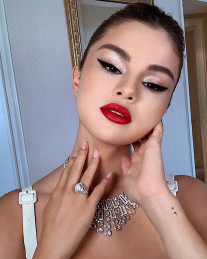 Selena Gomez is a cat eye connoisseur, but a sultry red pout makes her signature liner look even sexier. 