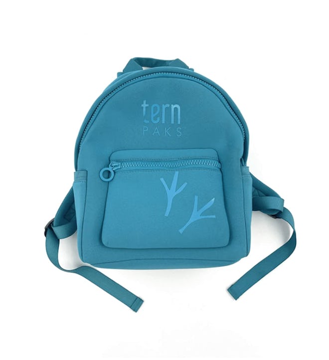Teal blue backpack with two tree branches in darker shade on the front