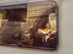 Young woman in a camper van in Tennessee, ready to post a pic with Nashville Instagram captions.