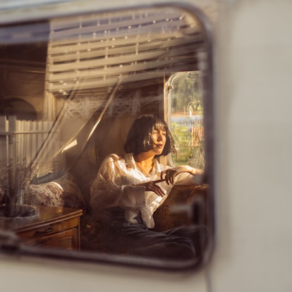 Young woman in a camper van in Tennessee, ready to post a pic with Nashville Instagram captions.