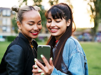 Smiling friends talking selfie before heading back to school and posting on Instagram with throwback...