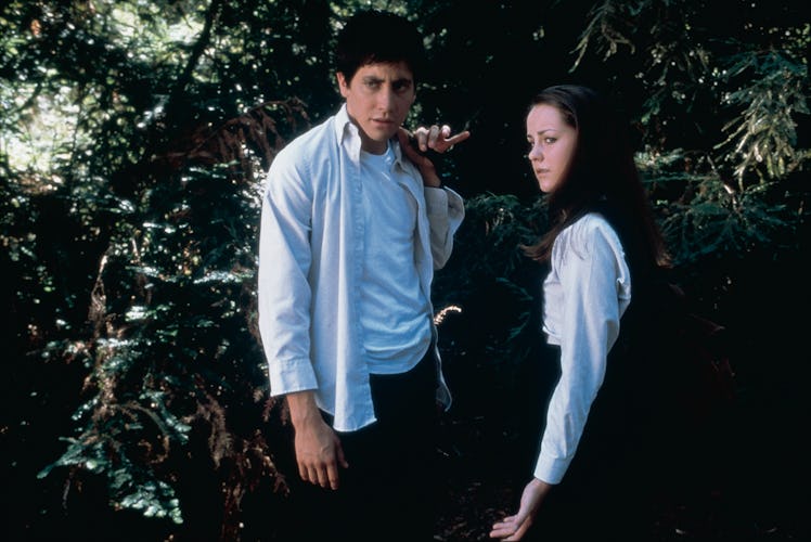 Jake Gyllenhaal and Jena Malone stand next to each other in Donnie Darko