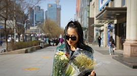 Young woman holding a bouquet of flowers, ready to post on Instagram with flower quotes and captions...