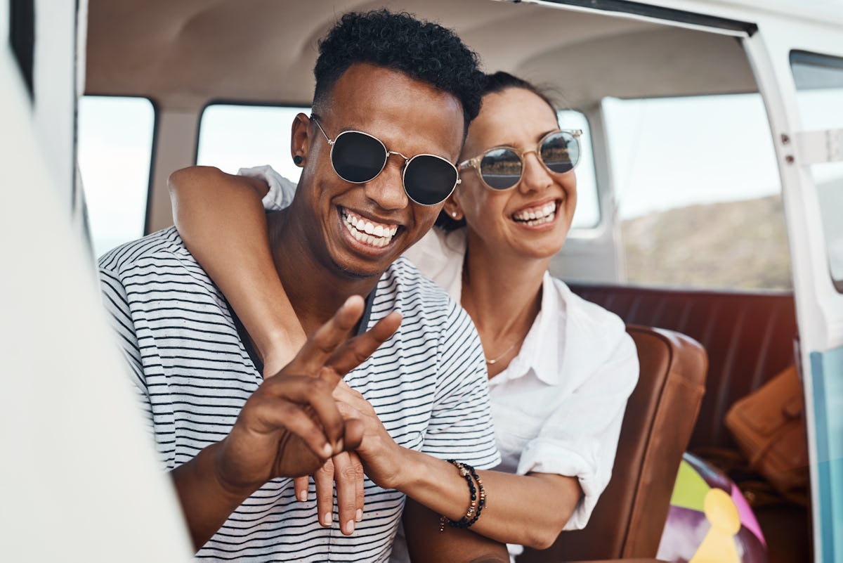 Young woman and Virgo man in love, giving the peace sign.