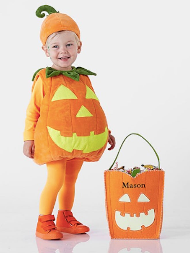 Child in a pumpkin costume