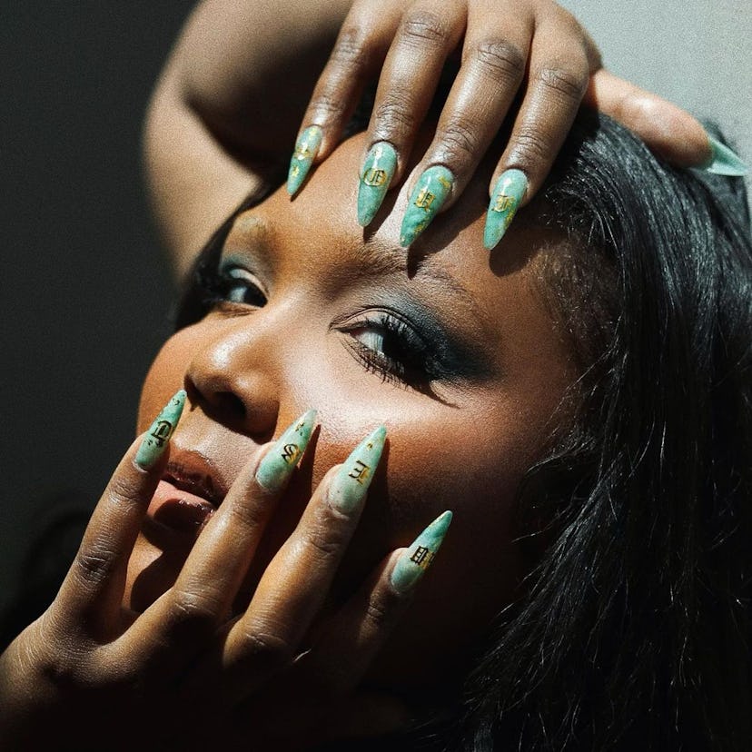 Lizzo showing jade nails