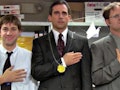Jim Halpert, Michael Scott, and Dwight Schrute stand on podiums for 'The Office' Olympics episode.