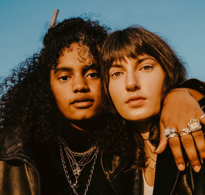 Two young women hugging while posing for a picture.