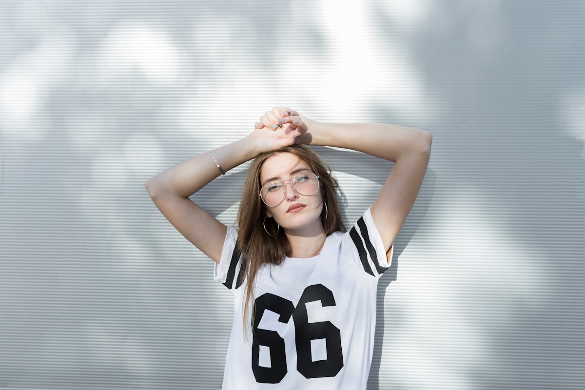 Young woman, wearing T-shirt with number 66, showing her most secret fear, according to her zodiac sign.