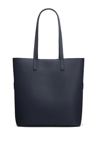 AWAY's Longitude Tote in navy leather that can hold a laptop. 
