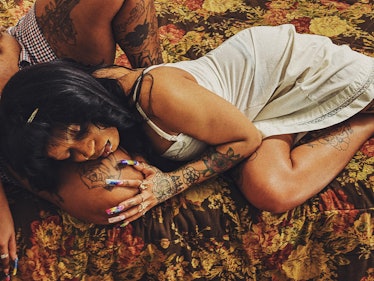 Photograph by Kennedi Carter with a woman lying and leaning her head on a man's thighs
